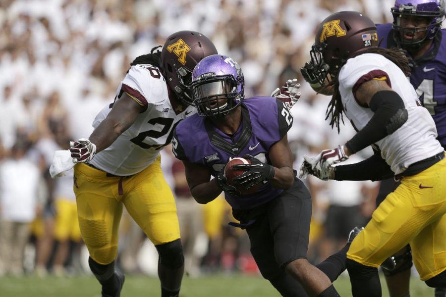 TCU running back Aaron Green (22) finds a hole against Minnesota defense during an NCAA college football game, Saturday, Sept. 13, 2014, in Fort Worth, Texas.(AP Photo/LM Otero)