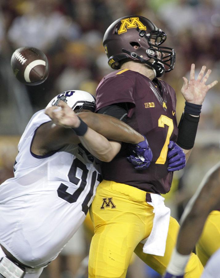 Minnesota quarterback Mitch Leidner (7) is stripped of the ball by TCU defensive end Terrell Lathan (90) during the first half of an NCAA college football game Thursday, Sept. 3, 2015, in Minneapolis. (AP Photo/Paul Battaglia)