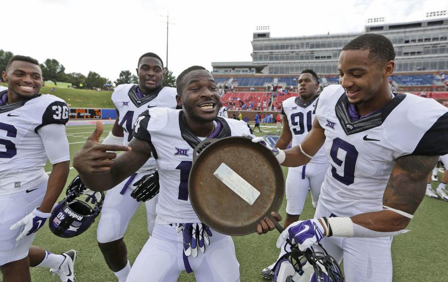 TCU+wide+receiver+David+Porter+%2814%29+shows+off+the+famed+iron+skillet+with+teammate+and+fellow+wide+receiver+Josh+Doctson+%289%29+after+their+56-0+win+over+SMU+in+an+NCAA+college+football+game++Saturday%2C+Sept.+27%2C+2014%2C+in+Dallas.++The+skillet+goes+the+the+winner+of+the+SMU-TCU+game+and+has+been+a+tradition+since+1915.+%28AP+Photo%2FLM+Otero%29