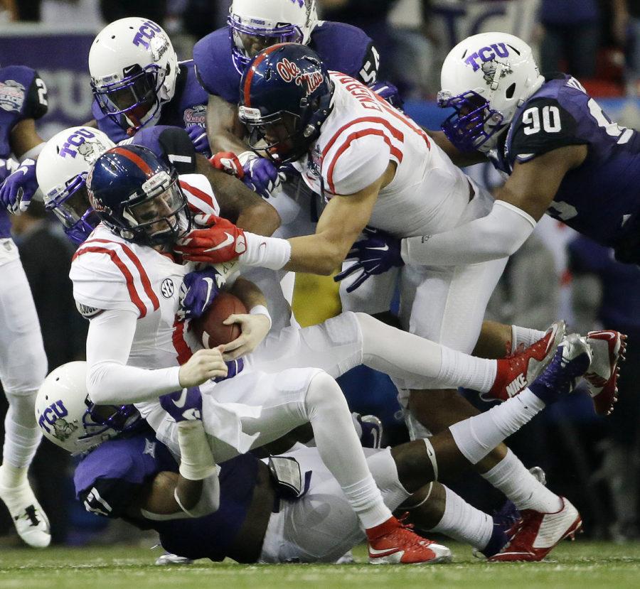 Mississippi quarterback Bo Wallace (14) is sacked my TCU during the first half of the Peach Bowl NCAA football game, Wednesday, Dec. 31, 2014, in Atlanta. (AP Photo/David Goldman)