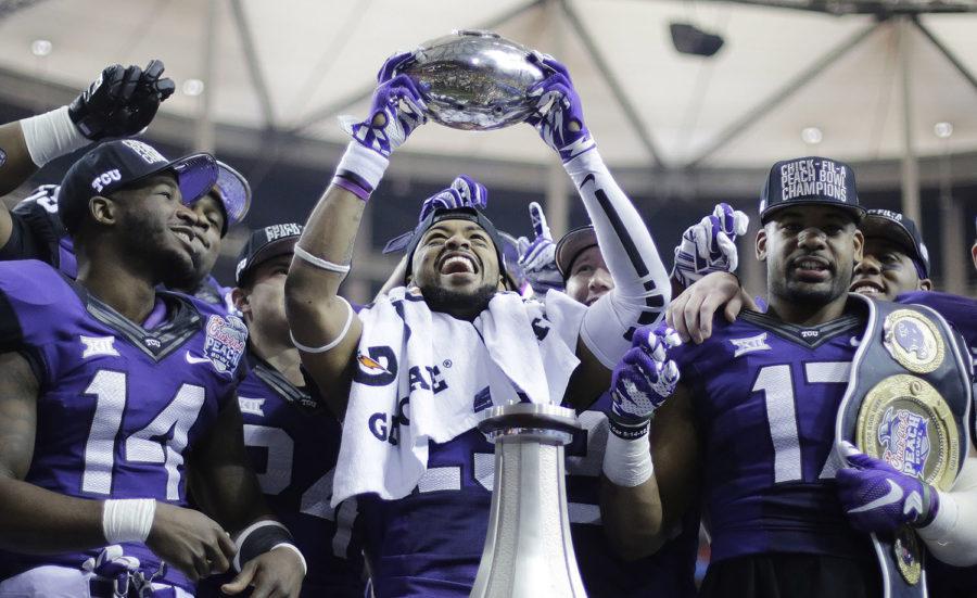 TCU+safety+Michael+Downing+holds+part+of+the+Peach+Bowl+trophy+after+the+second+half+of+the+Peach+Bowl+NCAA+football+game+against+Mississippi%2C+Wednesday%2C+Dec.+31%2C+2014%2C+in+Atlanta.+TCU+won+42-3.+%28AP+Photo%2FDavid+Goldman%29