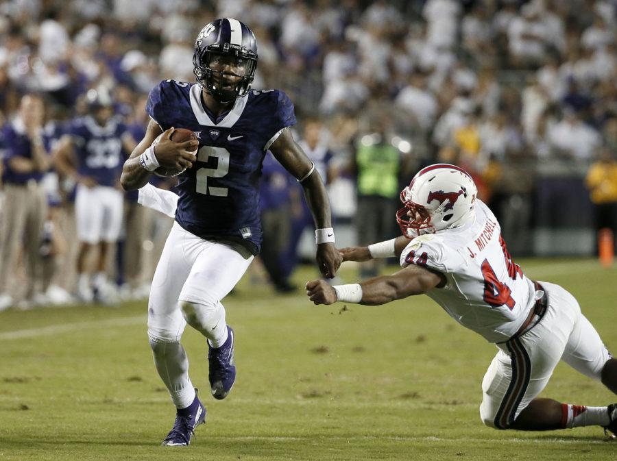 TCU quarterback Trevone Boykin (2) escapes a tackle attempt by SMUs Jackson Mitchell (44) in the second half of an NCAA college football game Saturday, Sept. 19, 2015, in Fort Worth, Texas. Boykin threw for 454 yards and five touchdowns and added a highlight scoring run when he ducked out of a sack as third-ranked TCU held on for a 56-37 victory over SMU on Saturday night. (AP Photo/Tony Gutierrez)
