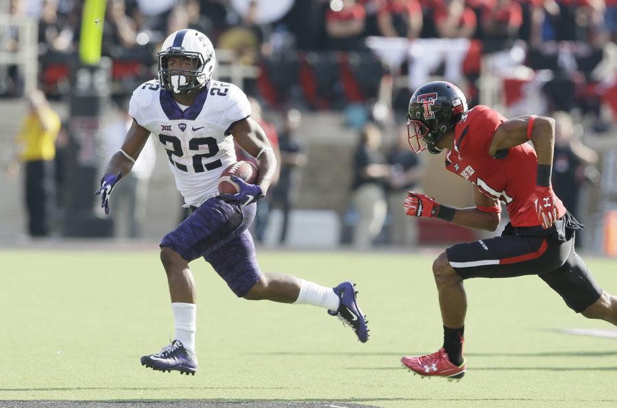TCU+running+back+Aaron+Green+%2822%29+finds+open+field+to+run+against+Texas+Tech+defensive+back+Justis+Nelson+%2831%29+during+the+first+half+of+an+NCAA+college+football+game+Saturday%2C+Sept.+26%2C+2015%2C+in+Lubbock%2C+Texas.+%28AP+Photo%2FLM+Otero%29