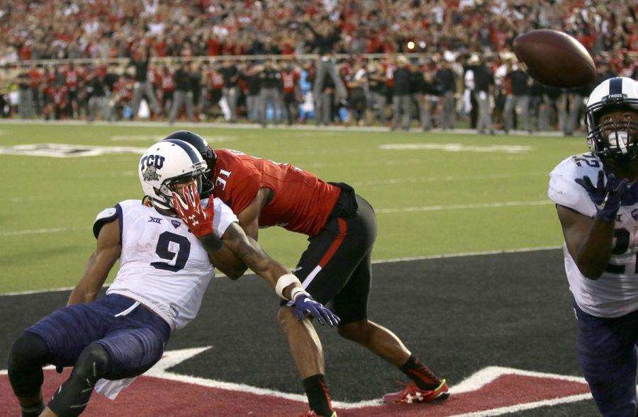 Texas Tech defensive back Justis Nelson (31) grabs TCU wide receiver Josh Doctson (9) after a pass was deflected to running back Aaron Green (22) for a touchdown during the fourth quarter of an NCAA college football game Saturday, Sept. 26, 2015, in Lubbock, Texas. TCU won 55-52. (AP Photo/LM Otero)