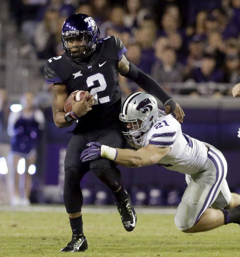 FILE+-+In+this+Nov.+8%2C+2014%2C+file+photo%2C+TCU+quarterback+Trevone+Boykin+%282%29+is+grabbed+by+Kansas+State+linebacker+Jonathan+Truman+%2821%29+during+the+first+quarter+of+an+NCAA+college+football+game+in+Fort+Worth%2C+Texas.+Boykin%2C+the+only+TCU+player+ever+with+a+200-yard+passing+game%2C+100-yard+receiving+game+and+100-yard+rushing+game+in+the+same+season+is+now+focused+only+on+being+the+quarterback+in+TCUs+new+up-tempo+offense%2C+with+the+No.+5+Horned+Frogs+in+playoff+contention+and+him+in+the+Heisman+conversation.+%28AP+Photo%2FLM+Otero%2C+File%29
