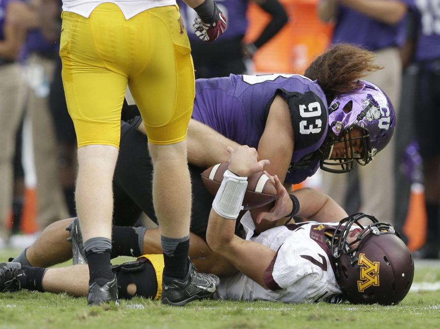 Minnesota quarterback Mitch Leidner (7) takes a hard hit from TCU defensive end Mike Tuaua (93) during the second half of an NCAA college football game, Saturday, Sept. 13, 2014, in Fort Worth, Texas.  Leidner left the game after the play. TCU won 30-7. (AP Photo/LM Otero)