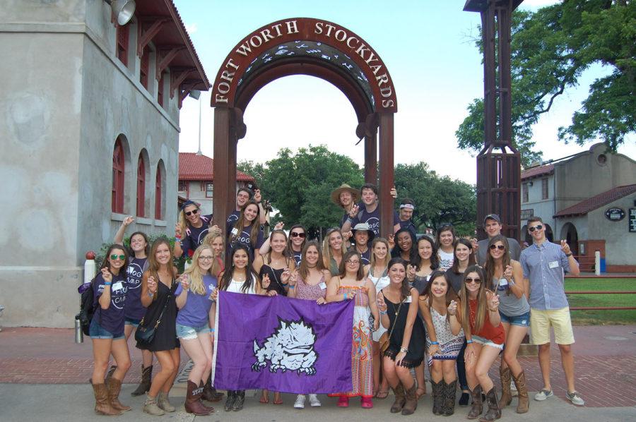 Participants of Frog Camp Casa Nueva pose in front of a picture of the Fort Worth Stockyards. The camp also includes trips to Billy Bobs and other iconic places in Fort Worth.