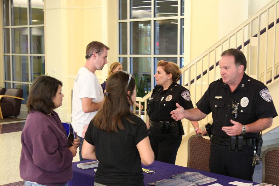 TCU Police Officers Pam Christian (left) and George Steen (right) inform students about crime prevention on campus. 