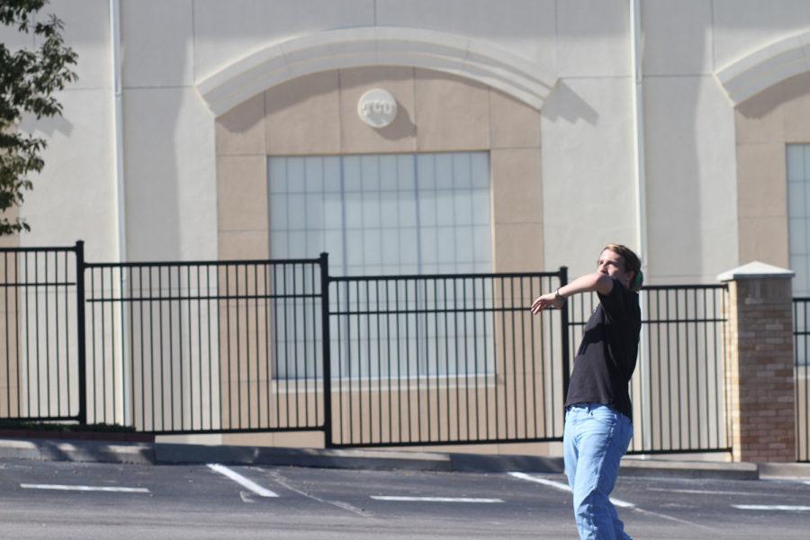 Bryan Smith throws a pass five and a half hours before kickoff while tailgating in the Sam Baugh parking lot