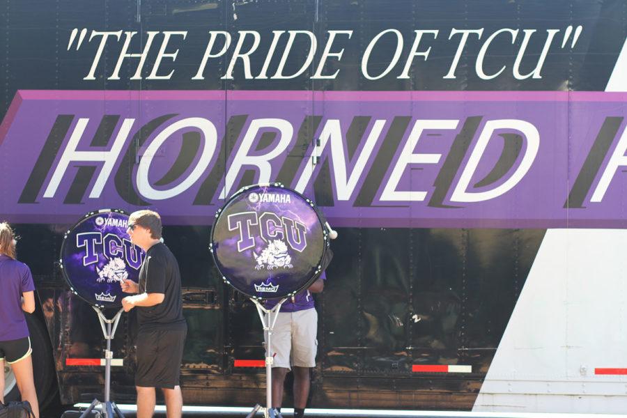 TCU Drumline prepares for game time in the shade of the TCU Band trailer