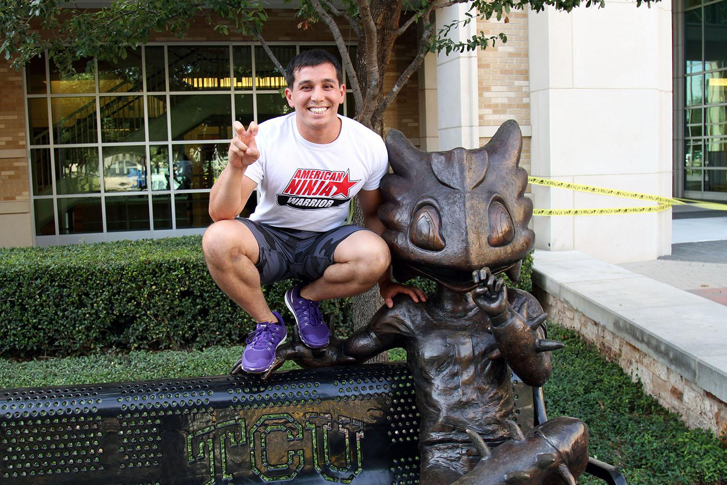 Kearney poses with the Horned Frog next to the Brown-Lupton University Union.