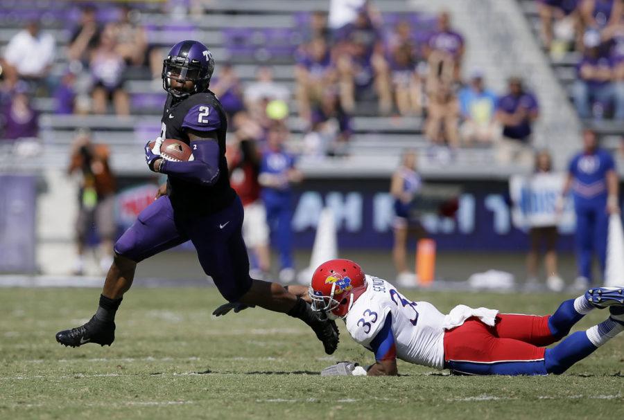 TCU quarterback Trevone Boykin (2) evades a tackle attempt by Kansas linebacker Cassius Sendish (33)  in the second half of an NCAA college football game, Saturday, Oct. 12, 2013, in Fort Worth, Texas. TCU won 27-17. (AP Photo/Tony Gutierrez)