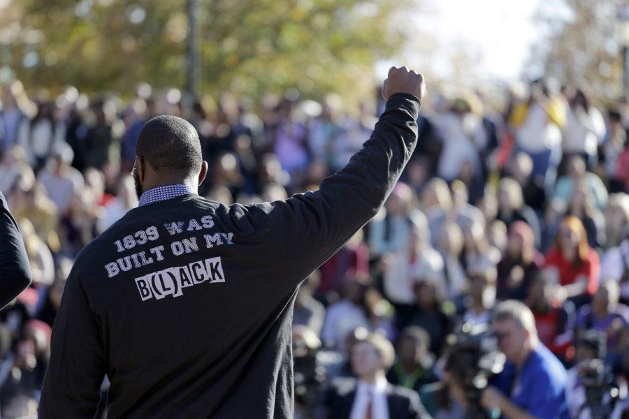 A member of the black student protest group Concerned Student 1950 gestures while addressing a crowd following the announcement that University of Missouri System President Tim Wolfe would resign Monday, Nov. 9, 2015, at the university in Columbia, Mo. Wolfe resigned Monday with the football team and others on campus in open revolt over his handling of racial tensions at the school. (AP Photo/Jeff Roberson)