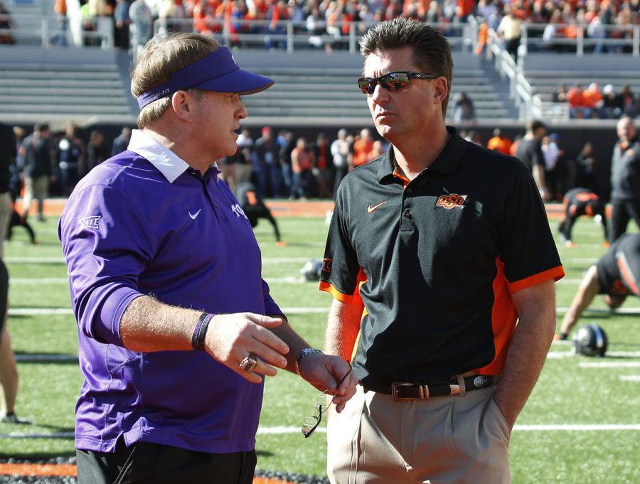 TCU head coach Gary Patterson, left, and Oklahoma State head coach Mike Gundy, right, talk before the start of an NCAA college football game in Stillwater, Okla., Saturday, Nov. 7, 2015. (AP Photo/Sue Ogrocki)