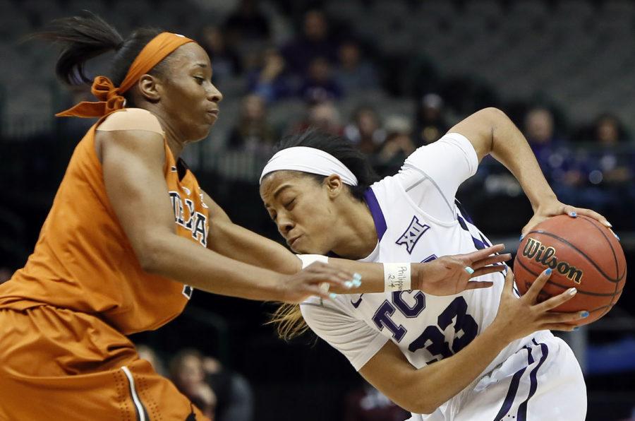 TCU guard Donielle Breaux (33) battles Texas guard Empress Davenport (1) for space during the first half of an NCAA college basketball game in the quarterfinals of the Big 12 Conference tournament, Saturday, March 7, 2015, in Dallas. Texas won 67-61. (AP Photo/Brandon Wade)