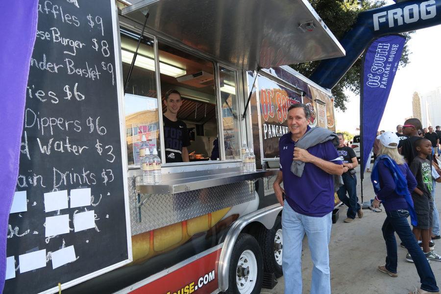Employees of Ol South Pancake House catering trailer serve food to tailgaters before TCU against West Virginia game got started.