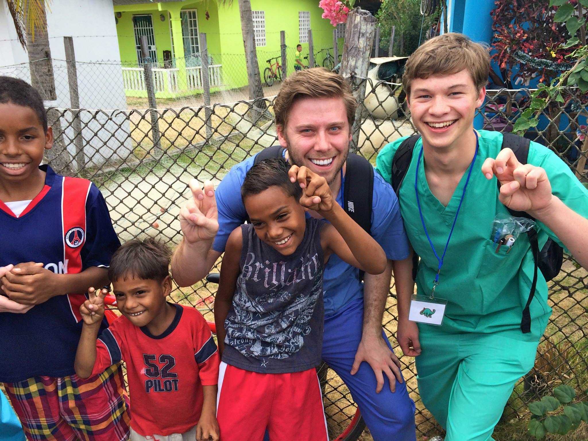 Sohn poses with fellow TCU student Robert Leonard and some of the children at the clinic in Panama. 