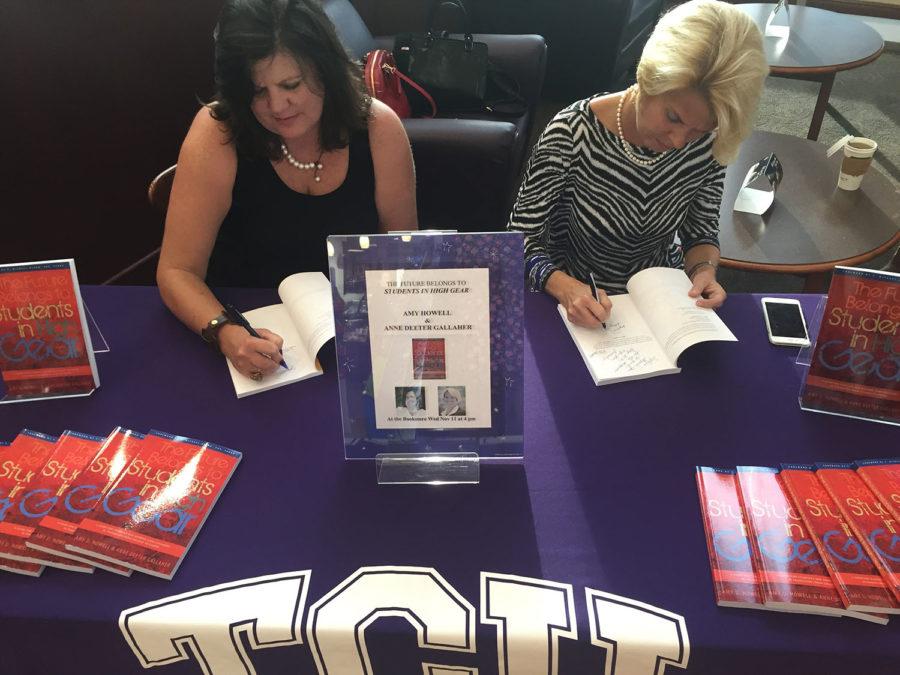 Authors Amy Howell (left) and Anne Gallaher (right) signing copies of their book Students in High Gear