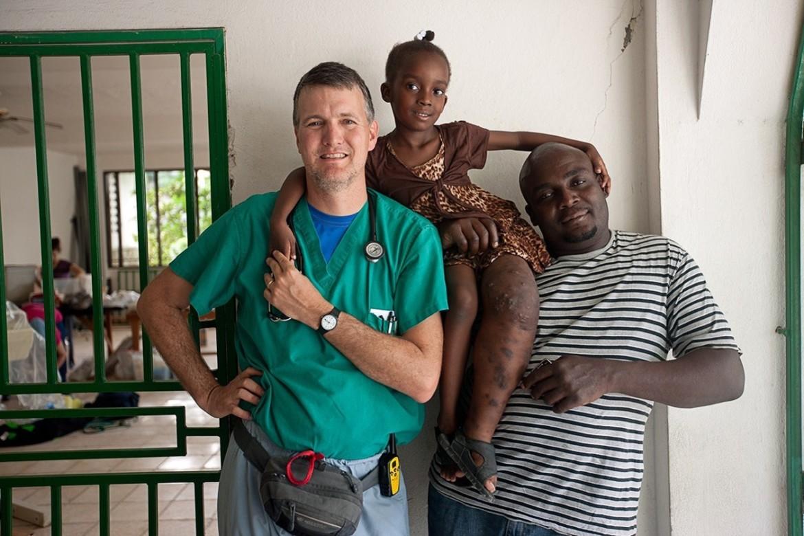 Dr. Ric Bonnell poses with Ruth and Moliere Jacques in Haiti. They lived with the Bonnells in Texas for a few months while she was receiving therapy for her leg malformation. 