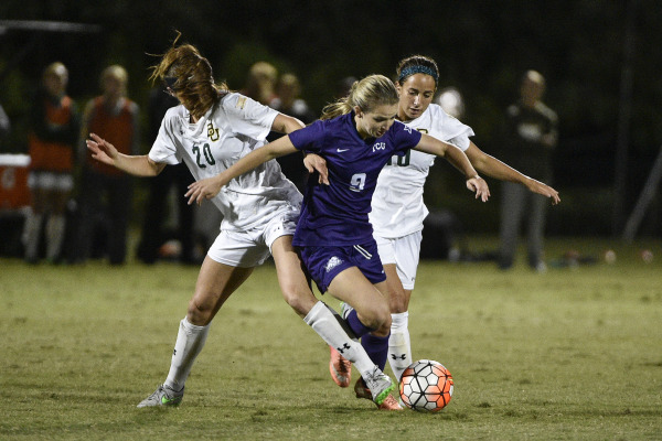 Kayla Hill attempts to escape two defenders in a draw against Baylor on Oct. 27 in Fort Worth.