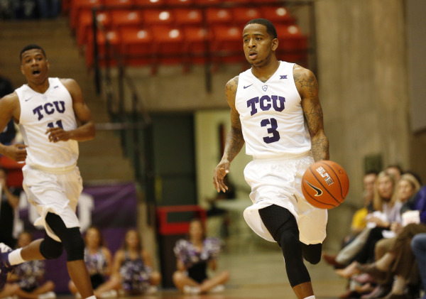 TCU guard Malique Trent dribbles the ball down the court.