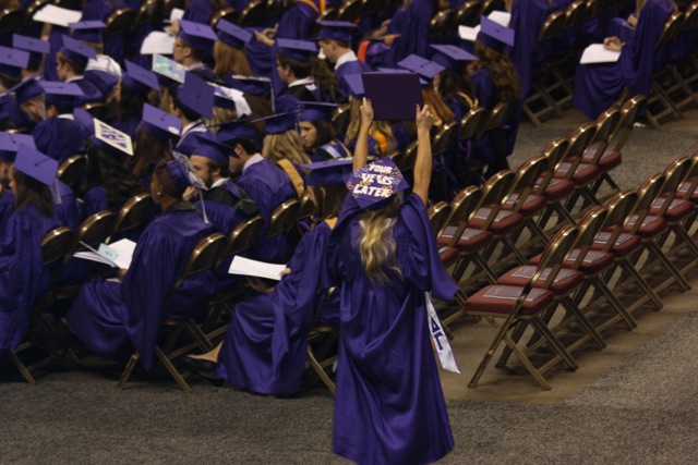 Strategic Communication major Elizabeth Greenwell celebrates with her diploma in Spring 2015.