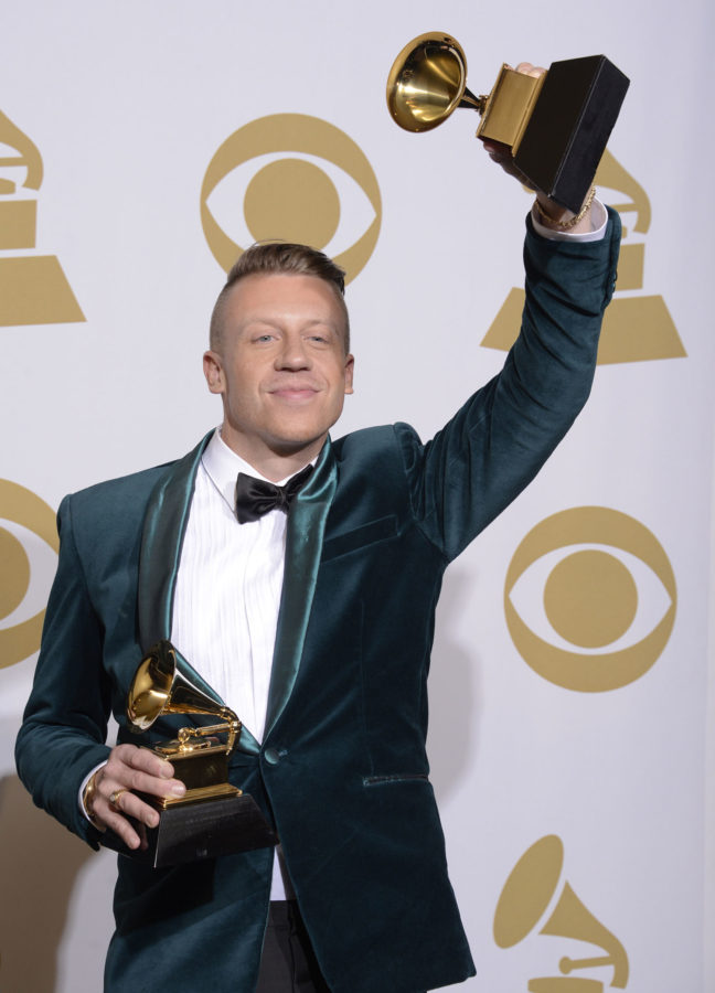 Macklemore poses in the press room with two of his awards after winning for best rap performance and best rap song, for Thrift Shop,  best rap album for The Heist and best new artist at the 56th annual Grammy Awards at Staples Center on Sunday, Jan. 26, 2014, in Los Angeles. (Photo by Dan Steinberg/Invision/AP)