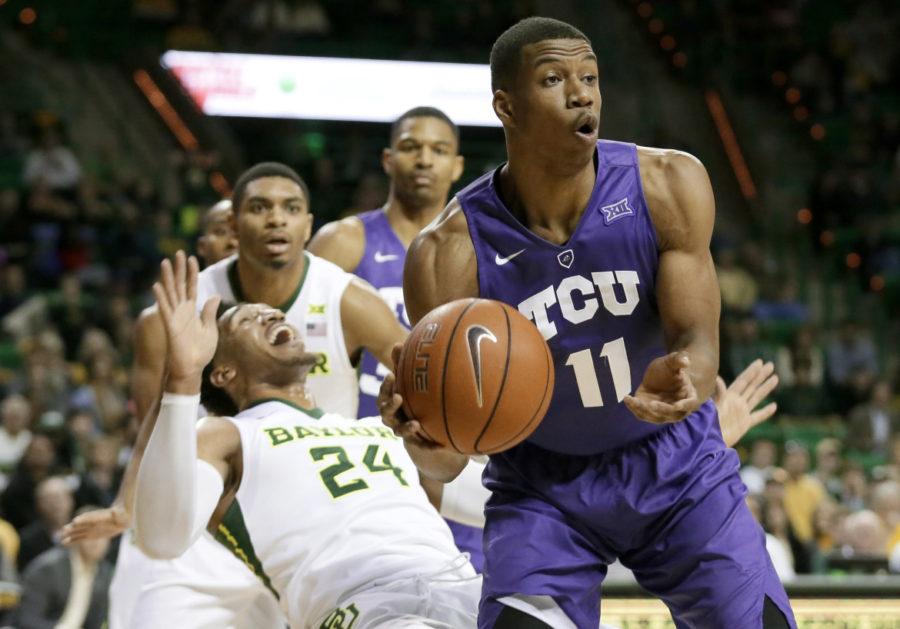 TCU guard Brandon Parrish (11) passes the ball after collecting an offensive rebound in front of Baylors Ishmail Wainright (24) in the first half of an NCAA college basketball game on Jan. 13 in Waco, Texas. 