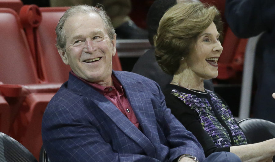 Former President George W. Bush sits with his wife Laura Bush before an NCAA college basketball game between Tulsa and SMU Wednesday, Feb. 10, 2016, in Dallas. (AP Photo/LM Otero)
