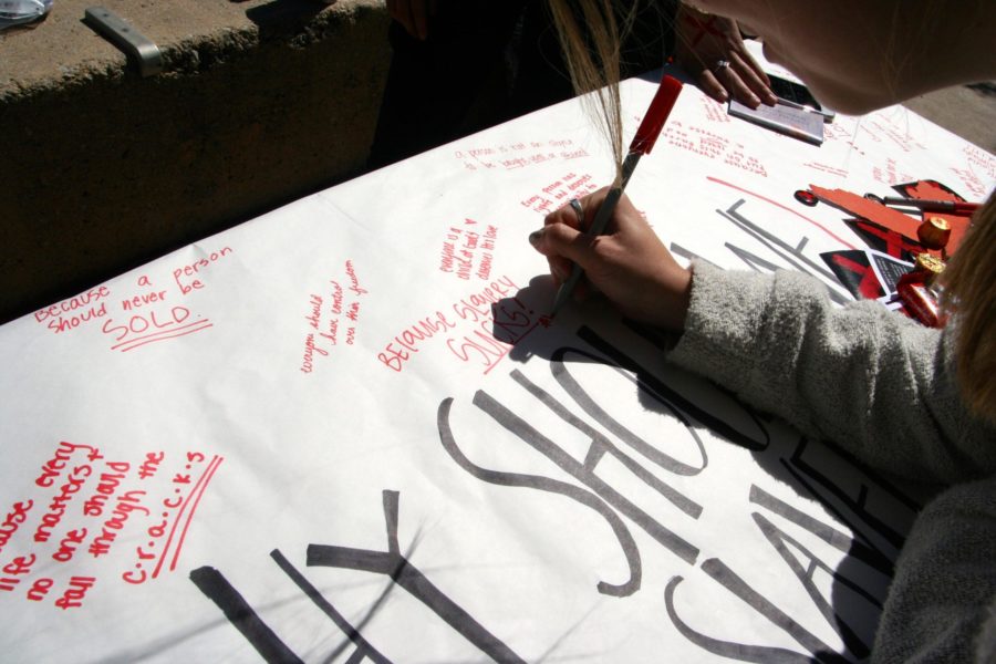 Passersby signed the table with reasons why slavery should end. 