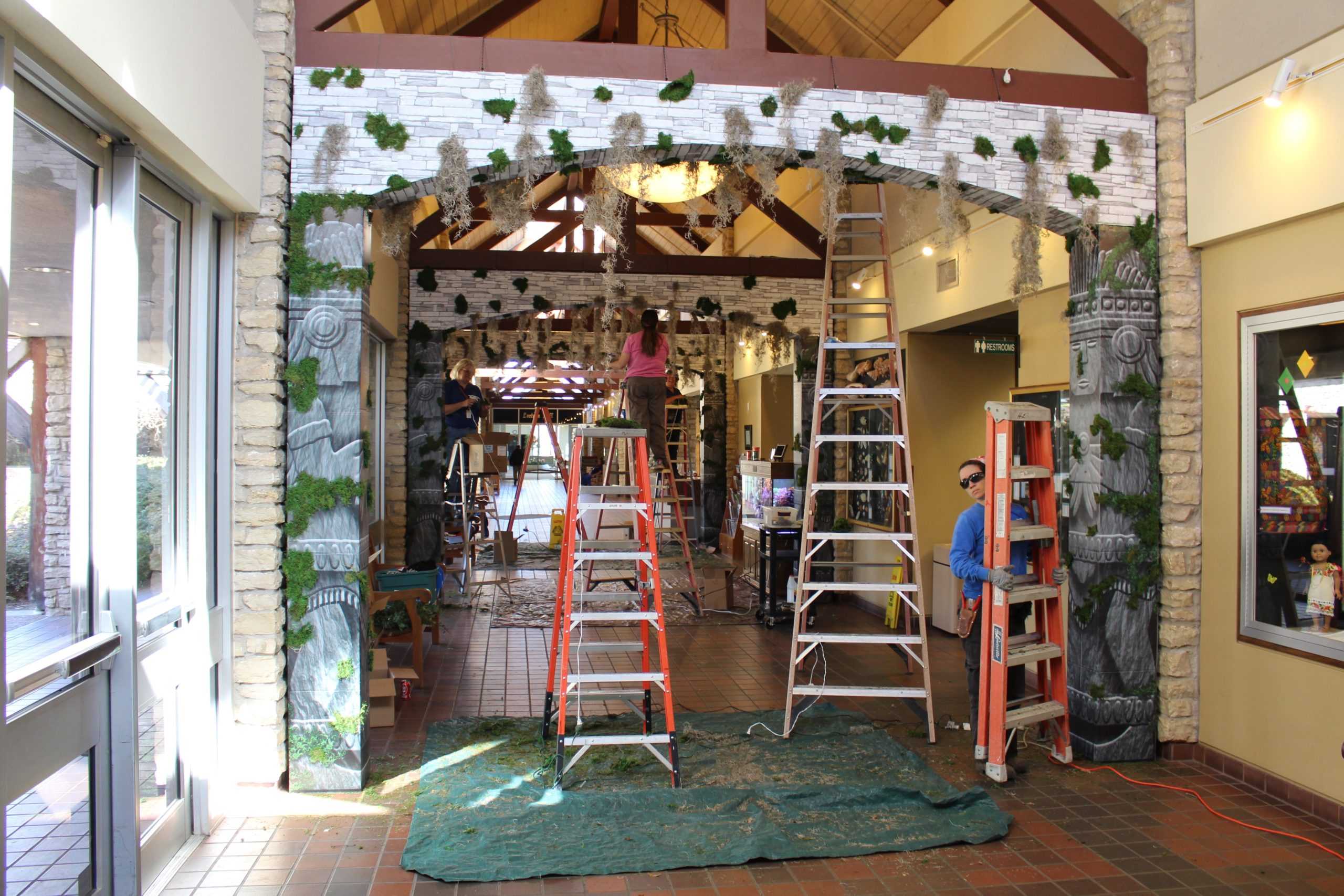 Workers preparing the Garden Center for the Butterfly exhibit.