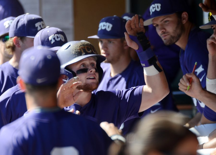 TCUs Evan Skoug celebrates with teammates in the dugout after scoring against West Virginia during the third inning of a college baseball game Saturday, March 19, 2016, in Fort Worth, Texas. 