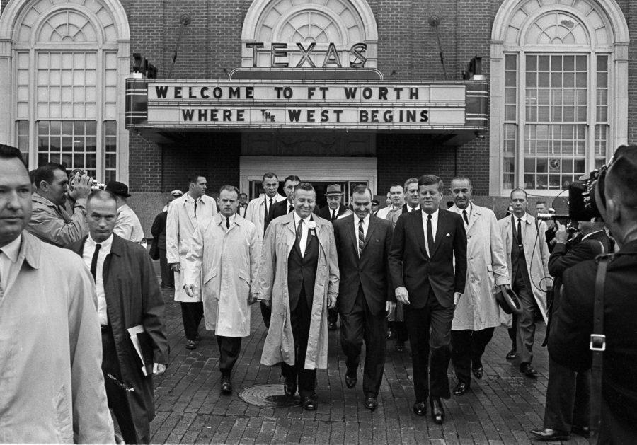 President John F. Kennedy, front, right, exits the Hotel Texas in Fort Worth, at 8:45 a.m., Nov. 22, 1963. He is on his way to greet crowds and make a speech. At right holding hat and wearing raincoat is Vice President Lyndon B. Johnson. (AP Photo)