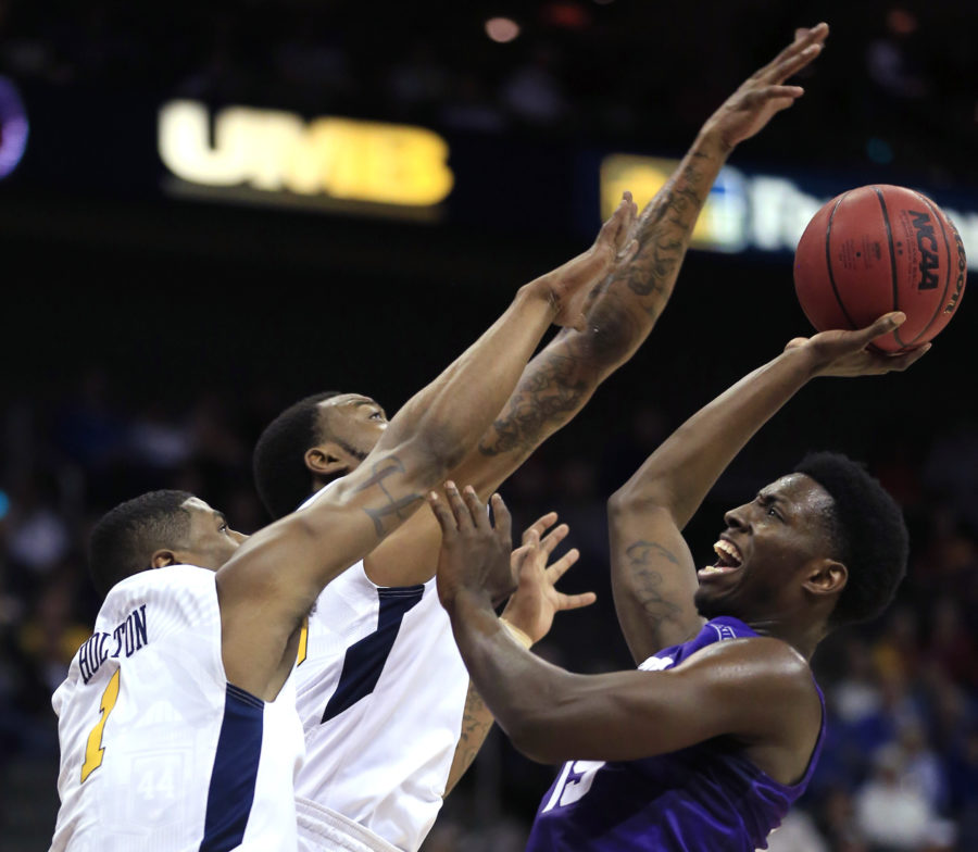 TCU forward JD Miller (15) shoots over West Virginia forwards Jonathan Holton (1) and Elijah Macon, middle, during the first half of an NCAA college basketball game in the quarterfinals of the Big 12 Conference mens tournament in Kansas City, Mo., Thursday, March 10, 2016. (AP Photo/Orlin Wagner)