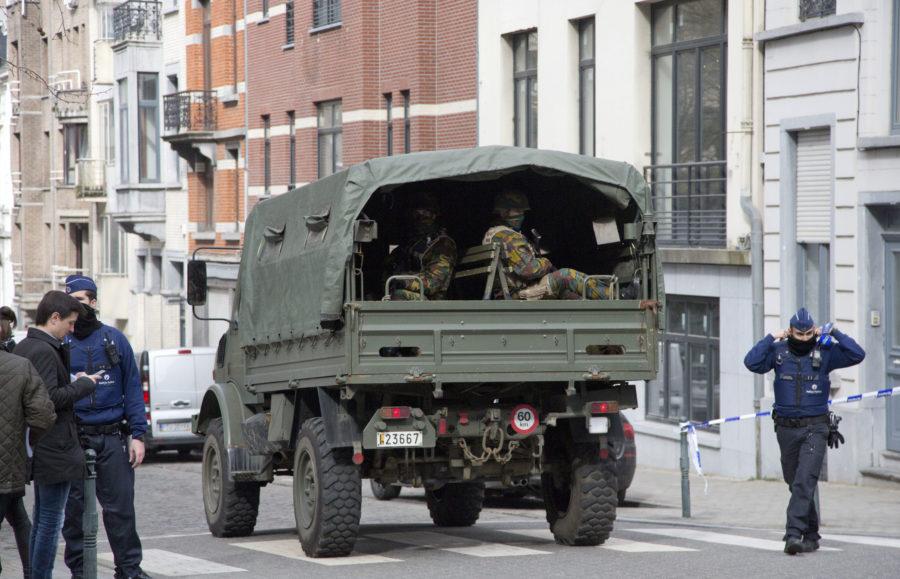 A truck carrying soldiers of the Belgian Army arrives after a explosion in a main metro station in Brussels on Tuesday, March 22, 2016. Explosions rocked the Brussels airport and the subway system Tuesday, killing at least 13 people and injuring many others just days after the main suspect in the November Paris attacks was arrested in the city, police said. (AP Photo/Virginia Mayo)