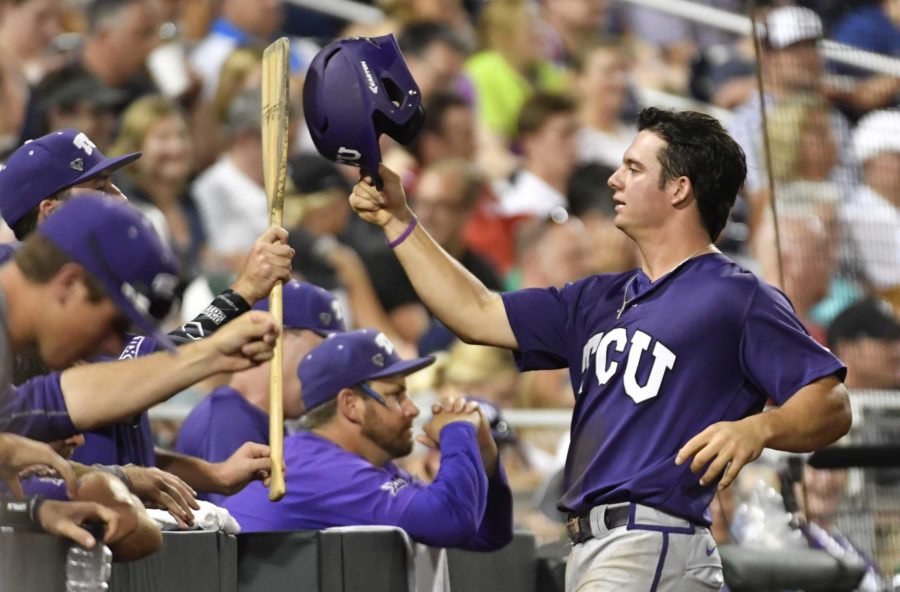 TCU's Josh Watson celebrates after scoring during the fifth inning of an NCAA College World Series baseball game against Coastal Carolina, Tuesday, June 21, 2016, in Omaha, Neb. (AP Photo/Ted Kirk)