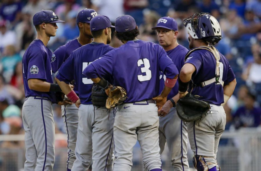 TCU coach Jim Schlossnagle, second from right, talks to his players during a trip to the mound during the fourth inning of an NCAA mens College World Series baseball game against Coastal Carolina in Omaha, Neb., Saturday, June 25, 2016. (AP Photo/Nati Harnik)