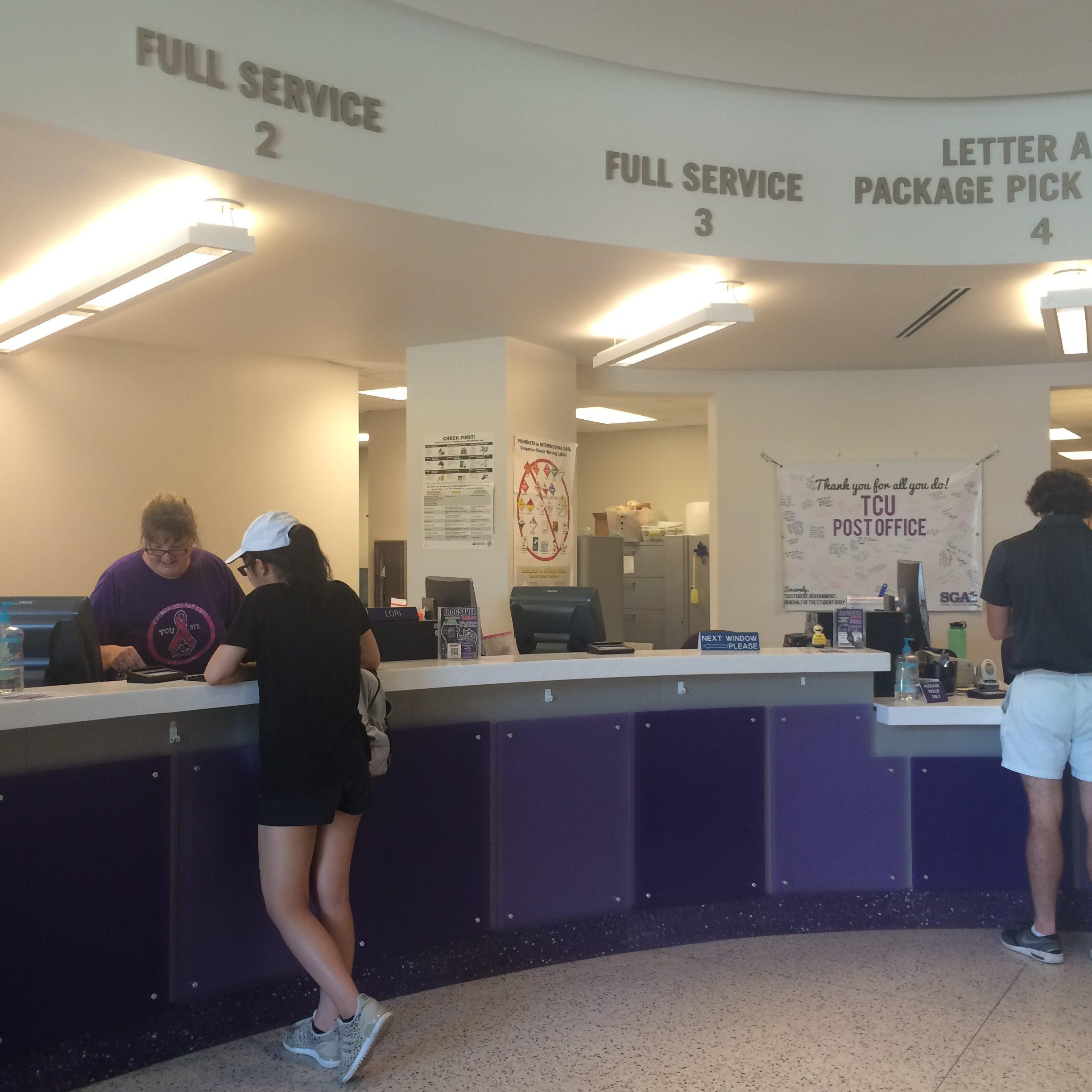 Staff members of the TCU post office attend to students receiving packages or mail. 