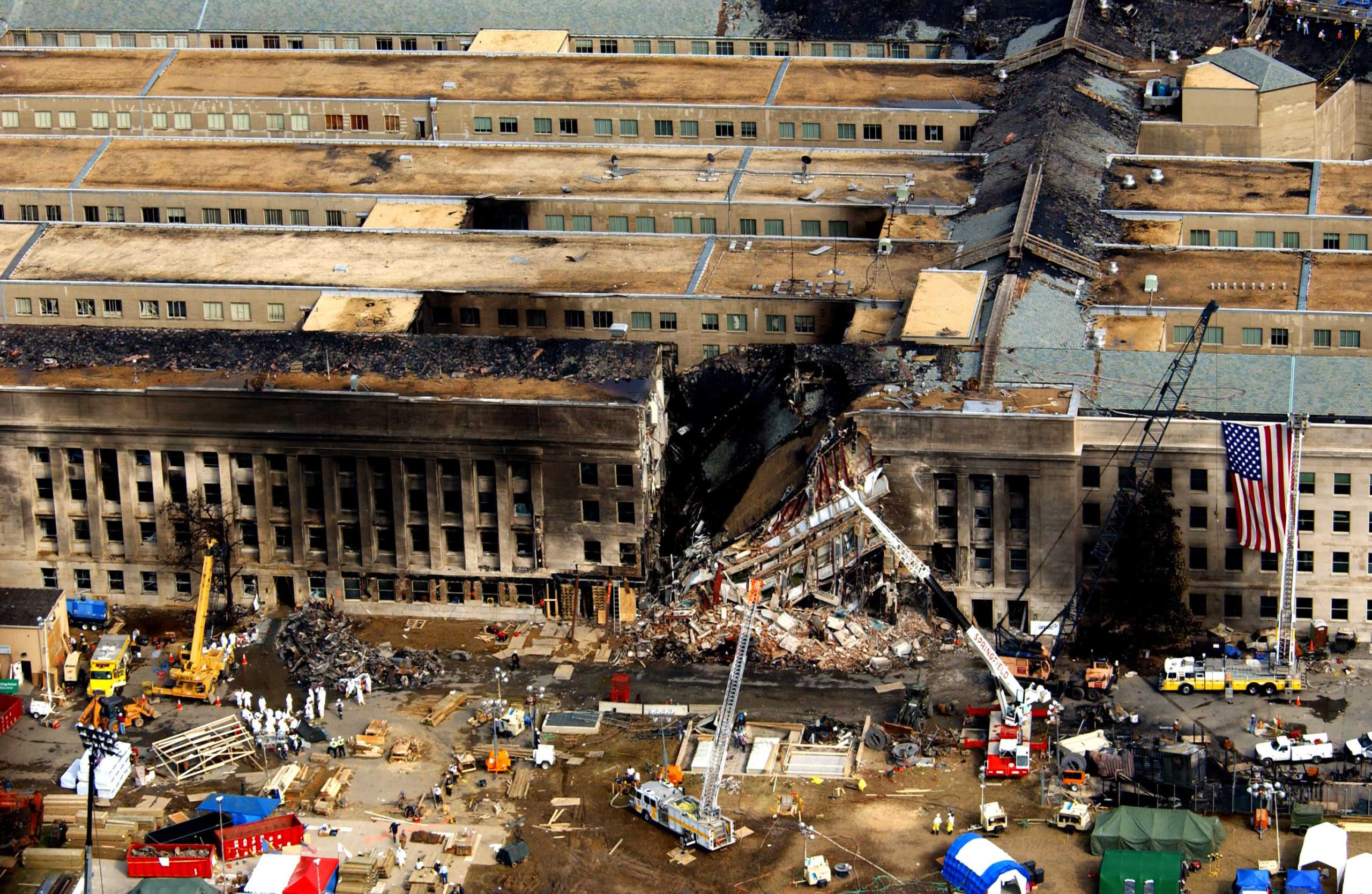 0 1 0 9 1 4 - F - 8 0 0 6 R - 0 0 2 FBI agents, fire fighters, rescue workers and engineers work at the Pentagon crash site on Sept. 14, 2001, where a high-jacked American Airlines flight slammed into the building on Sept. 11. The terrorist attack caused extensive damage to the west face of the building and followed similar attacks on the twin towers of the World Trade Center in New York City. DoD photo by Tech. Sgt. Cedric H. Rudisill. (Released)