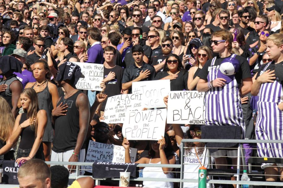 A group of students sat down during the National Anthem at the TCU football game against Oklahoma. (Photo Credits: Sam Bruton)