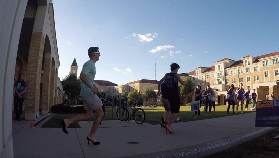 TCU AXO hosted a relay race for men in heels to raise awareness about domestic violence.