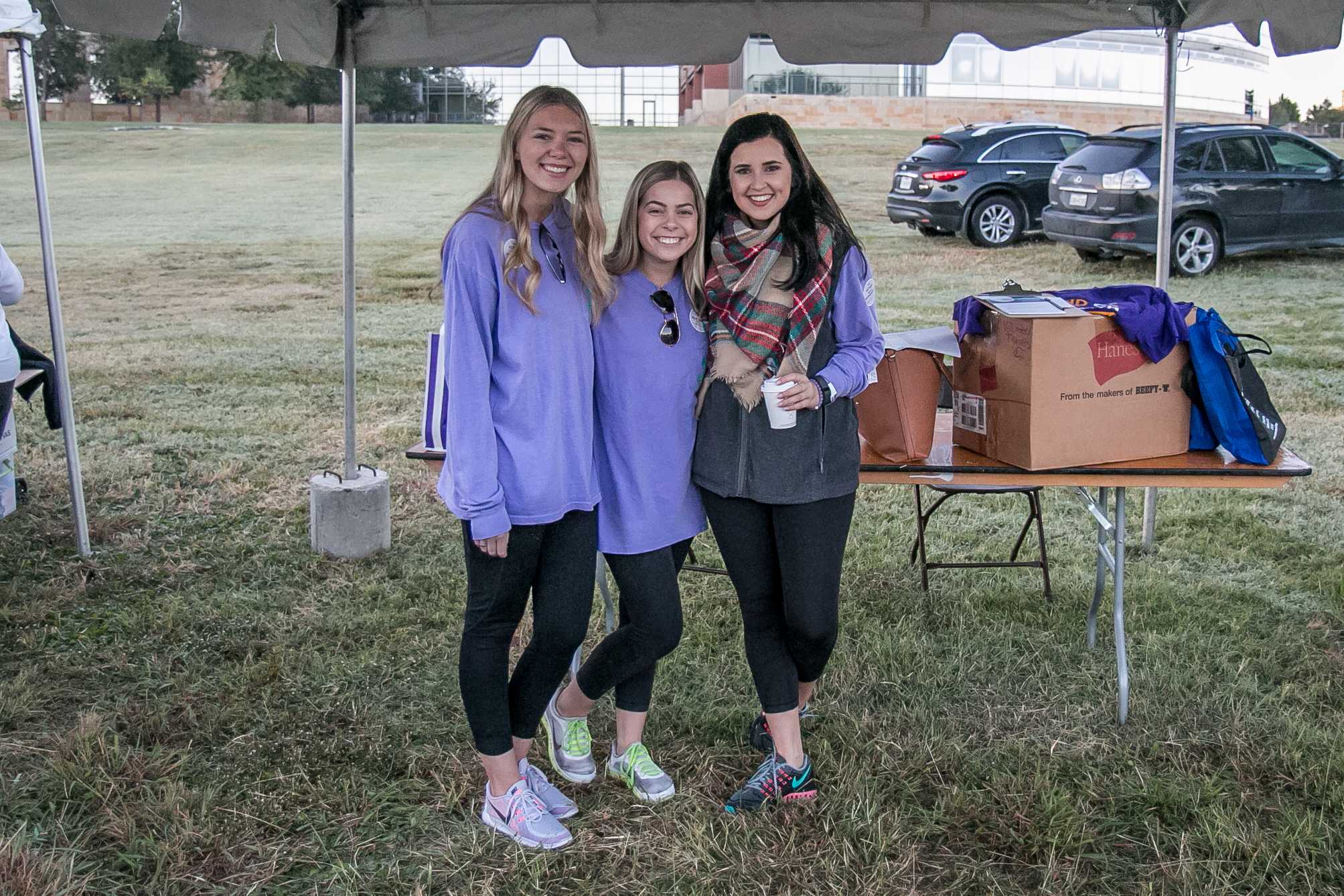Sigma Kappa seniors Christa Martin, Christina DeMarois and sophomore Charlee Bisch stand under the Sigma Kappa tent getting ready to ask walk participants to sign advocacy cards (Photo courtesy: Alzheimer's Association North Central Texas Chapter).