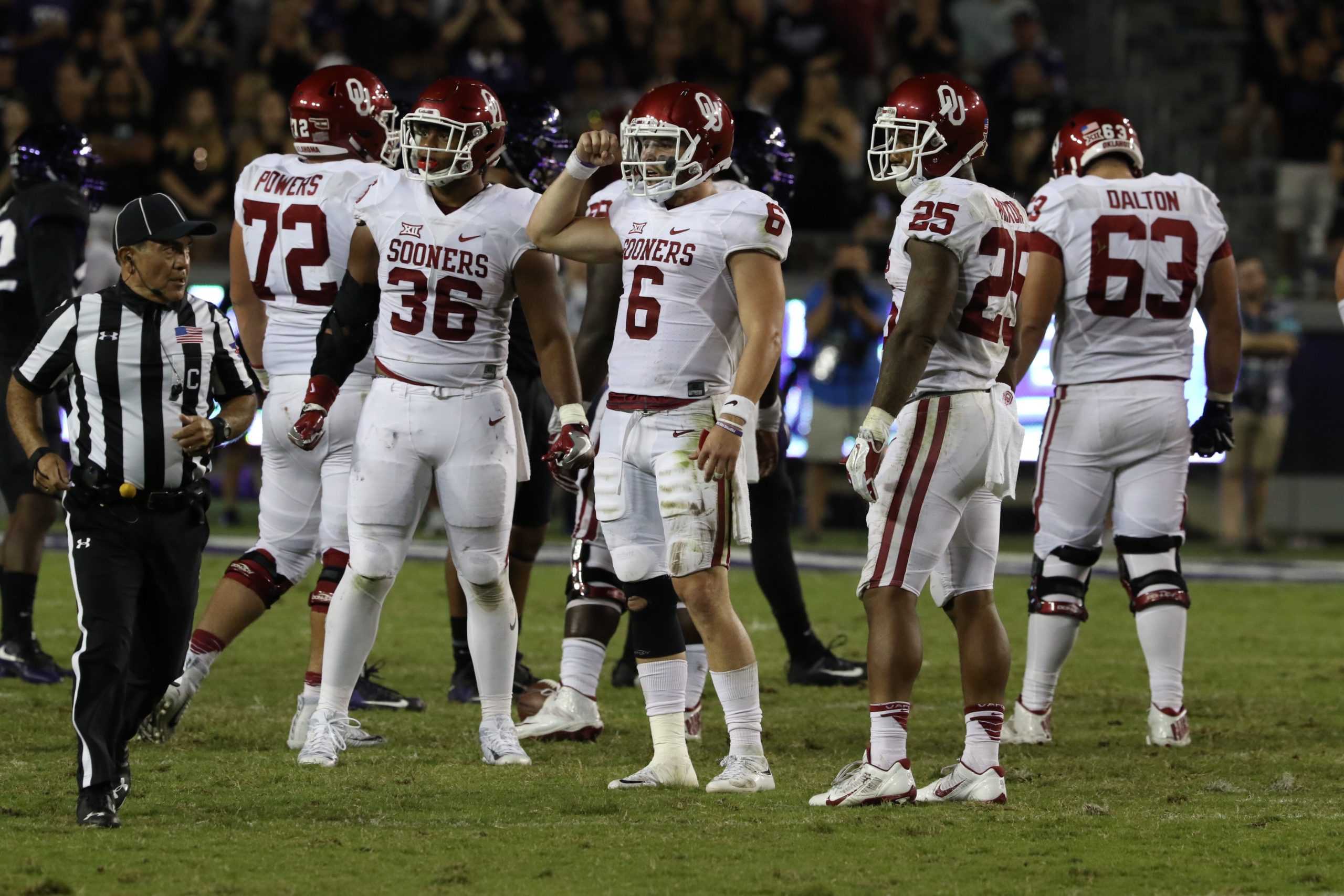 Oklahoma quarterback Baker Mayfield huddles with his teammates against TCU Saturday night. (Sam Bruton/TCU staff photographer)