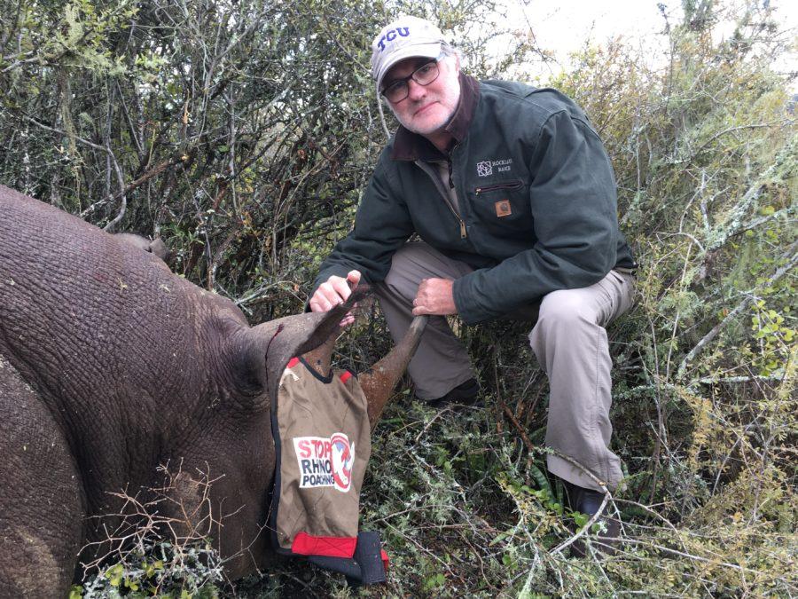 Dr. Mike Slattery posed with a black rhino darted for DNA sampling and ID tagging. (Photo courtesy of Mike Slattery)