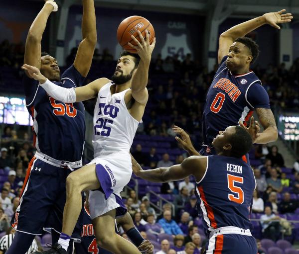 TCU Horned Frogs guard Alex Robinson (25) goes to the basket on Auburn Tigers center Austin Wiley (50) and forward Horace Spencer (0) and guard Mustapha Heron (5) during the first half at Ed and Rae Schollmaier Arena. (Ray Carlin-USA TODAY Sports)