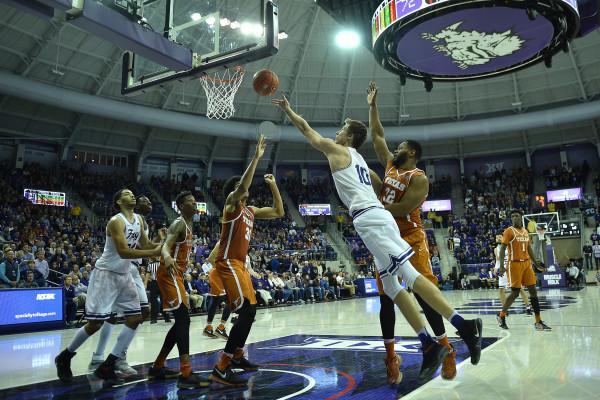 Vladimir Brodziansky (10) lays in a bucket with the Texas defense draped around him. (Photo Courtesy of GoFrogs.com)