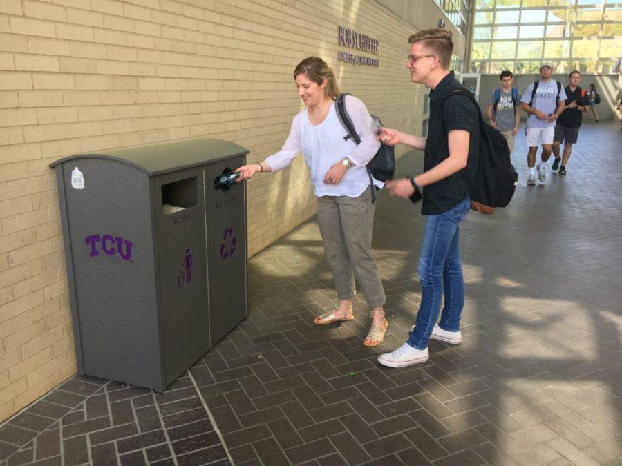 Photo by Madison Fowler Sophomore students, Eliza Barrow (left) and Stanton Cross (right) using the recycling bin outside of Moudy South. 
