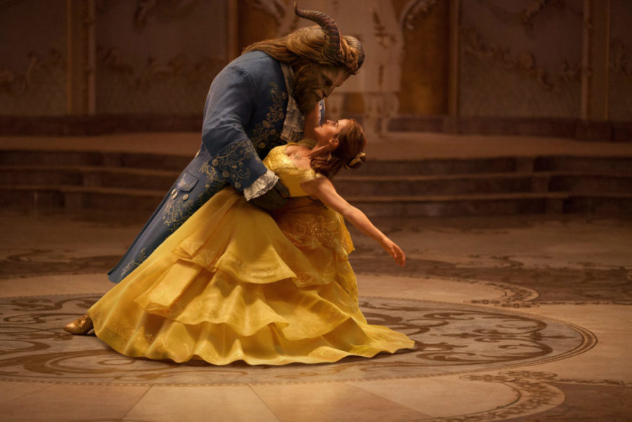 This image released by Disney shows Dan Stevens as The Beast, left, and Emma Watson as Belle in a live-action adaptation of the animated classic Beauty and the Beast. (Disney via AP) 