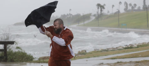 Matt Looingvill struggles with his umbrella as he tries to walk in the wind and rain, Friday, Aug. 25, 2017, in Corpus Christi, Texas. Harvey intensified into a hurricane Thursday and steered for the Texas coast with the potential for up to 3 feet of rain, 125 mph winds and 12-foot storm surges in what could be the fiercest hurricane to hit the United States in almost a dozen years.(AP Photo/Eric Gay)