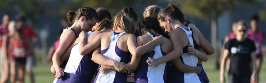 Womens cross country prepares before their race.